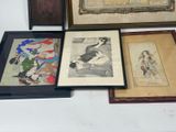 several framed art pieces of asian art on display on a table