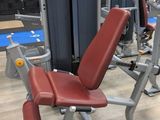 a gym room with a row of machines and other equipment