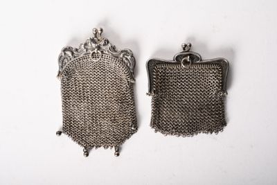 pair of antique silver metal mesh purses on a white background