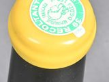 a close up of a bottle of beer with a yellow cap