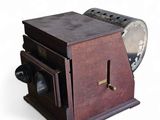 a small wooden box with a fan on top of it