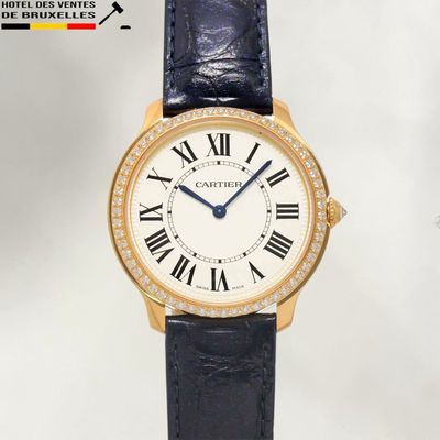 an image of a gold wrist watch with roman numerals and diamonds