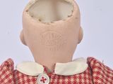 a doll that is wearing a red and white checkered dress