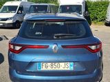 a blue car parked in a parking lot next to other cars
