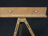 a small wooden tripod with three buttons on it
