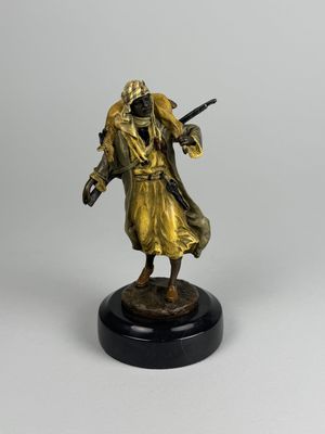 a statue of a man with a gun on a black base