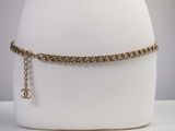 gold chain choke with a cross charm on a mannequin base
