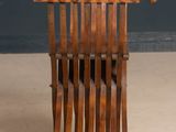an old wooden chair with a wooden seat and a wooden back