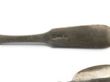 two spoons that are sitting next to each other