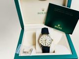 an image of a rolex watch in a box on a white background