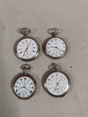 four different types of pocket watches are displayed on a table