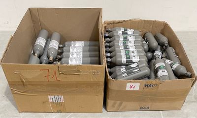 two boxes of oxygen bottles sitting on the floor