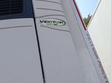 a white truck with a green and black logo on it