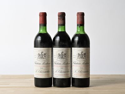 three bottles of wine sitting on top of a wooden table