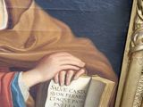 a painting of a woman holding a book in her hands