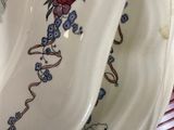 two plates with flowers on them sitting on a table