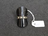 a close up of a ring on a table with a price tag