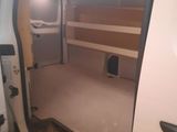 a white van with the door open in a garage