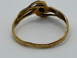 a close up of a gold ring on a white surface
