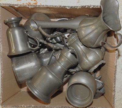 a cardboard box full of old metal items that are in it