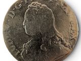an old silver coin with a woman ' s profile on it