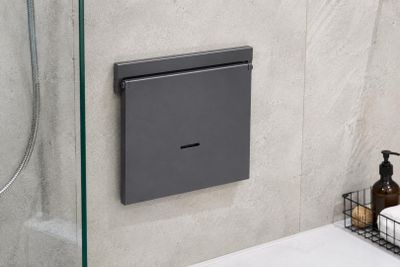 a bathroom with a glass shower door and a soap dispenser