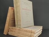 several books stacked on top of each other on a table