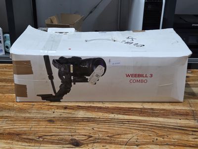a box with a camera attached to it on a wooden table