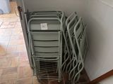 a lot of chairs that are stacked up on the floor
