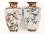 two vases sitting side by side on a white surface