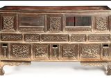 a wooden chest of drawers with many drawers on it