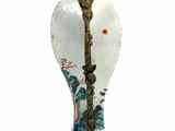 a white vase with a blue and gold decoration on it