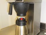 a coffee maker sitting on a counter in a kitchen