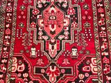 a red and black rug with a design on it