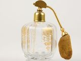 a glass bottle with a gold handle on a white background