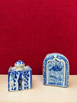 two small blue and white ceramic objects on a table