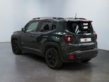 the back of a green jeep compass parked in a room