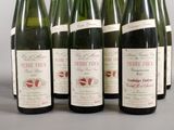 six bottles of wine are lined up in a row on a table