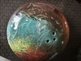a bowling ball with writing on it sitting on a table