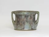 a close up of a cup on a white surface