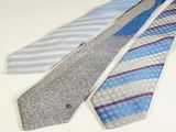 three ties are lined up on a table with a white background