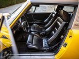 a yellow car with black leather seats in the back of it