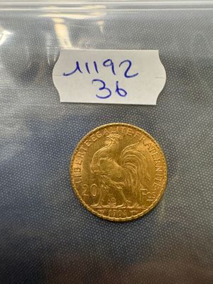 a close up of a gold coin with a label on it