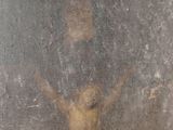 an old painting of a man on a cross on a wall