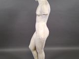 a white marble statue of a man standing on a square base