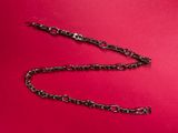 a close up of a chain on a red surface
