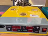 an image of a yellow and grey machine sitting on top of a table