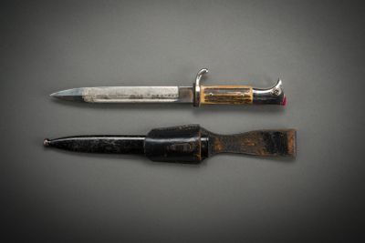 two different types of knives on a gray surface
