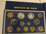 french coins in a box on a table with a price tag