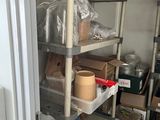 a metal shelving with many items on it in a room